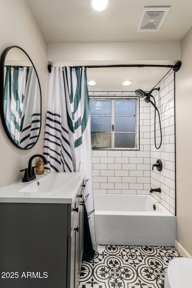 bathroom with toilet, vanity, visible vents, tile patterned floors, and shower / bath combo with shower curtain