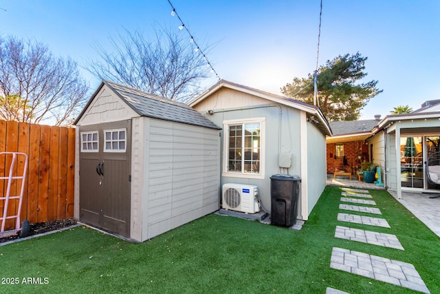 view of shed featuring ac unit and fence