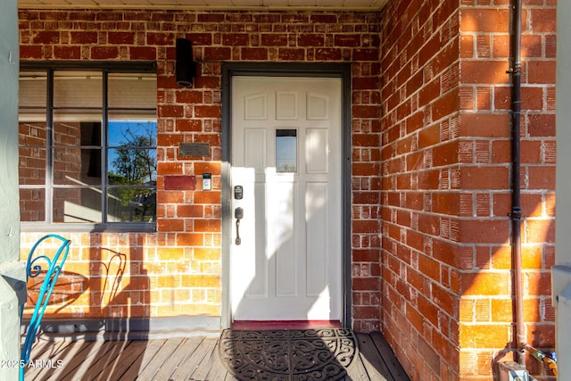 entrance to property with brick siding