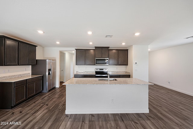 kitchen featuring light stone counters, sink, dark wood-type flooring, and stainless steel appliances