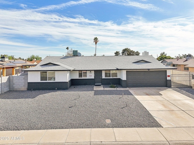 single story home featuring an attached garage, central air condition unit, brick siding, fence, and concrete driveway