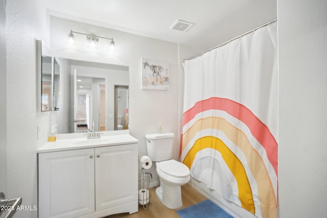 full bathroom featuring visible vents, toilet, a shower with curtain, wood finished floors, and vanity