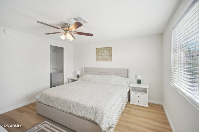 bedroom featuring light wood-style floors, visible vents, ceiling fan, and baseboards