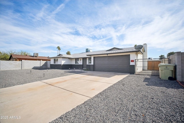 ranch-style home with a garage, a gate, driveway, and fence