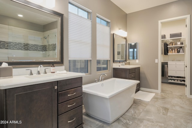 bathroom featuring vanity and shower with separate bathtub