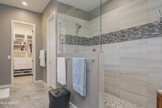 bathroom featuring vanity and tiled shower