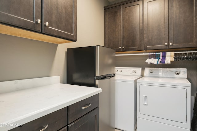 laundry room with cabinets and washer and clothes dryer