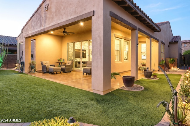 back of house with a yard, ceiling fan, and a patio area