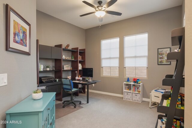 carpeted office featuring ceiling fan