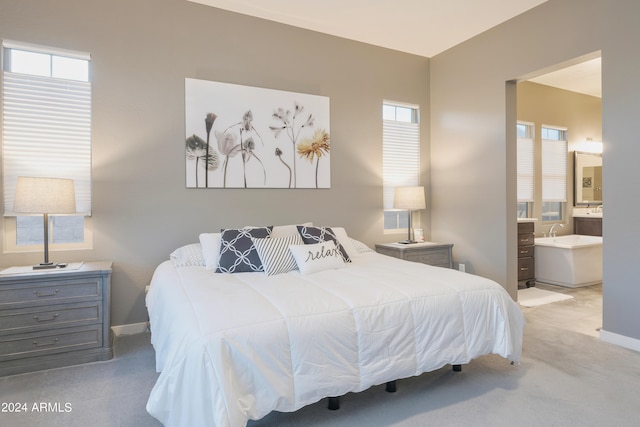 carpeted bedroom featuring connected bathroom