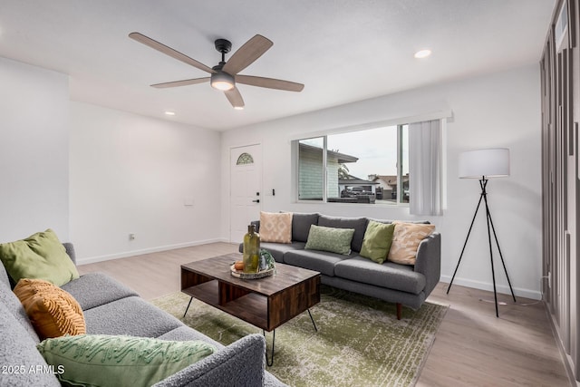 living room with ceiling fan and light wood-type flooring