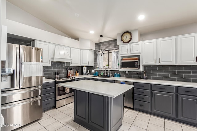 kitchen with light countertops, stainless steel appliances, a sink, custom range hood, and gray cabinets
