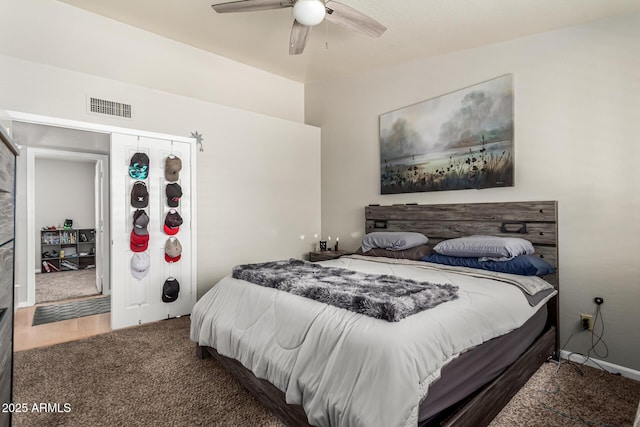 carpeted bedroom with ceiling fan and visible vents