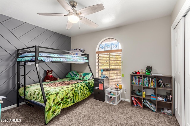 bedroom featuring baseboards, a closet, ceiling fan, and carpet flooring