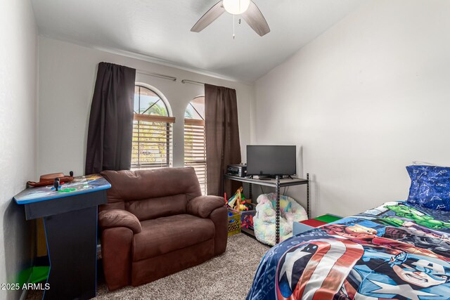 carpeted bedroom featuring a ceiling fan and lofted ceiling