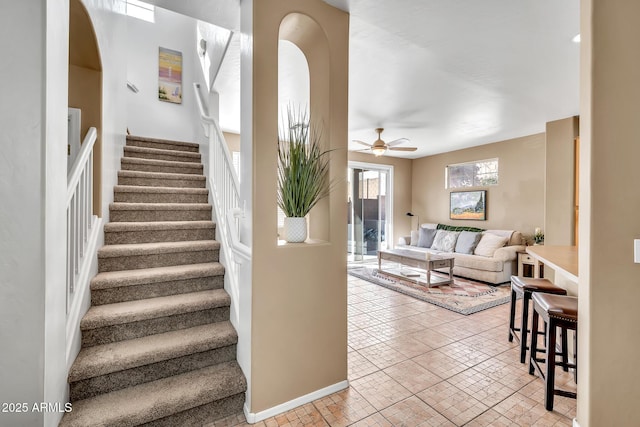 450 W Mountain Sage Dr, Phoenix, AZ 85045 - stairs featuring ceiling fan, baseboards, and arched walkways