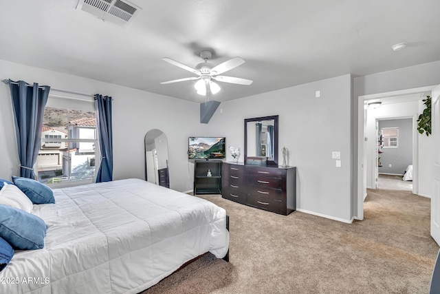 450 W Mountain Sage Dr, Phoenix, AZ 85045 - bedroom featuring light carpet, arched walkways, baseboards, and ceiling fan