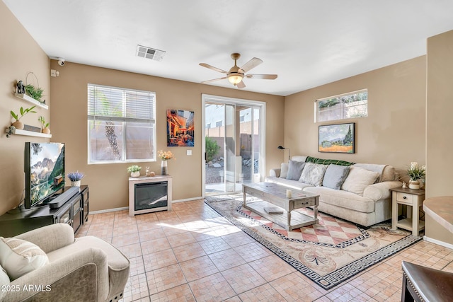 450 W Mountain Sage Dr, Phoenix, AZ 85045 - living room featuring healthy amount of natural light, ceiling fan, baseboards, and light tile patterned floors