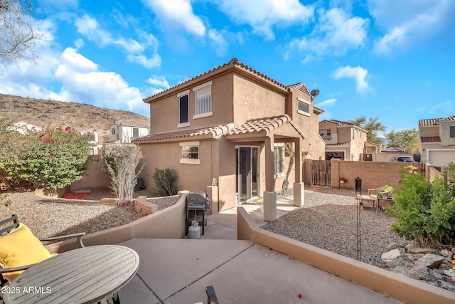 450 W Mountain Sage Dr, Phoenix, AZ 85045 - back of house featuring stucco siding, a patio area, a tiled roof, and a fenced backyard