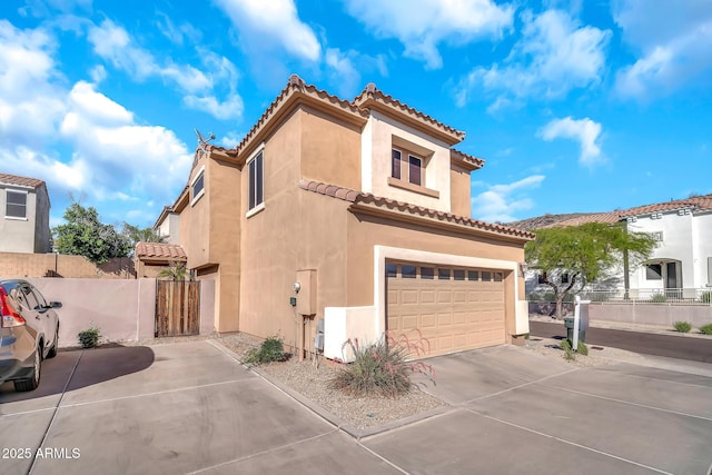 450 W Mountain Sage Dr, Phoenix, AZ 85045 - mediterranean / spanish-style house with stucco siding, a garage, a tile roof, driveway, and a gate
