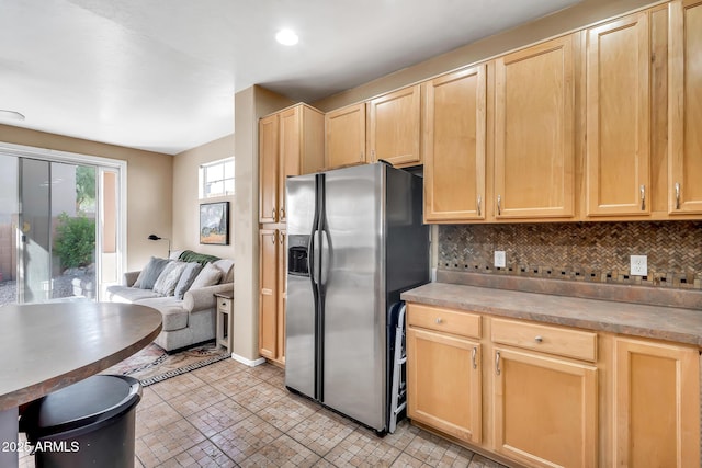 450 W Mountain Sage Dr, Phoenix, AZ 85045 - kitchen featuring stainless steel refrigerator with ice dispenser, light brown cabinetry, decorative backsplash, and open floor plan
