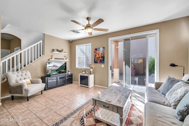 450 W Mountain Sage Dr, Phoenix, AZ 85045 - living area with a ceiling fan, stairway, baseboards, and light tile patterned flooring