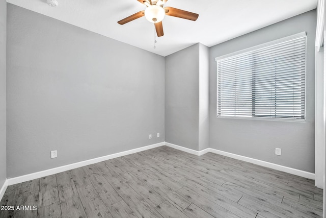 spare room featuring ceiling fan and light hardwood / wood-style flooring