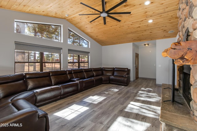 living room with wood ceiling, high vaulted ceiling, hardwood / wood-style flooring, ceiling fan, and a fireplace