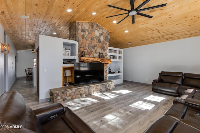 living room featuring hardwood / wood-style floors, a fireplace, lofted ceiling, ceiling fan, and wooden ceiling