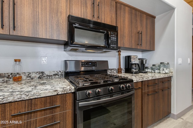 kitchen with light stone counters and stainless steel range with gas cooktop