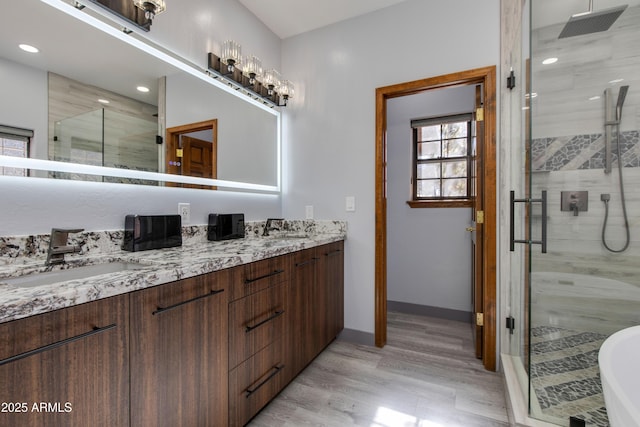 bathroom with vanity, hardwood / wood-style floors, and an enclosed shower