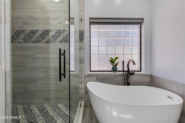 bathroom featuring separate shower and tub, sink, a wealth of natural light, and tile walls