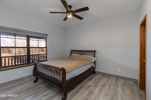 bedroom featuring ceiling fan and light hardwood / wood-style floors