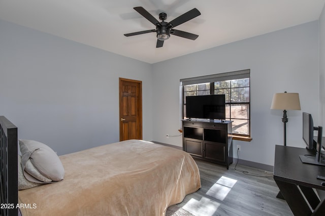 bedroom featuring hardwood / wood-style flooring and ceiling fan