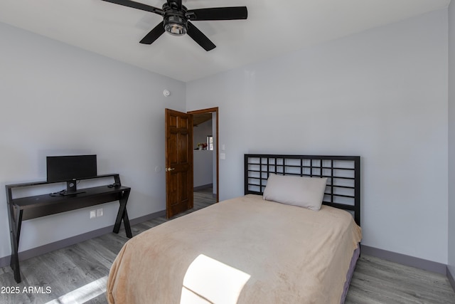 bedroom featuring hardwood / wood-style flooring and ceiling fan