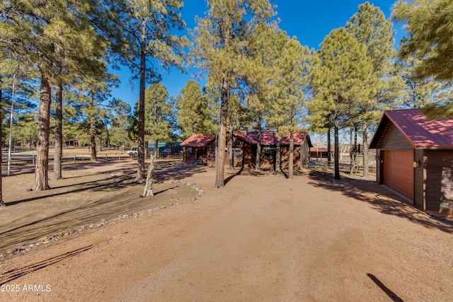 view of front of home with a garage and an outdoor structure