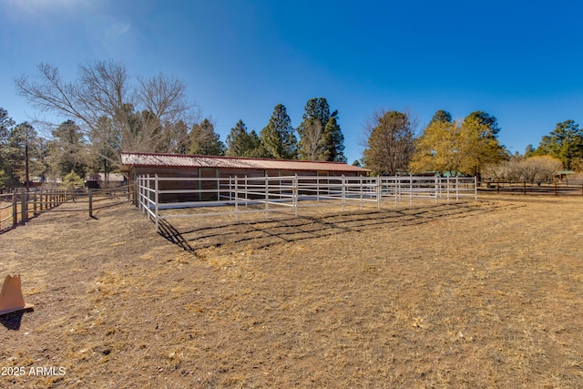 view of stable with a rural view