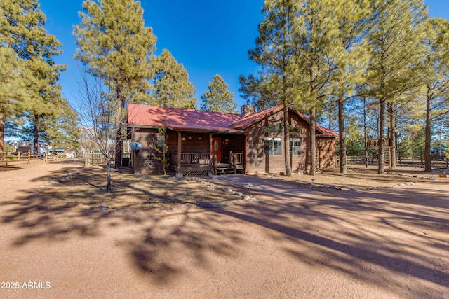 log-style house featuring a porch