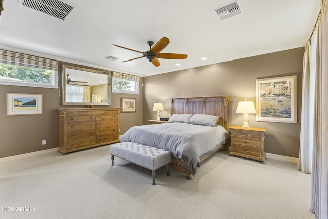 carpeted bedroom featuring ceiling fan and crown molding