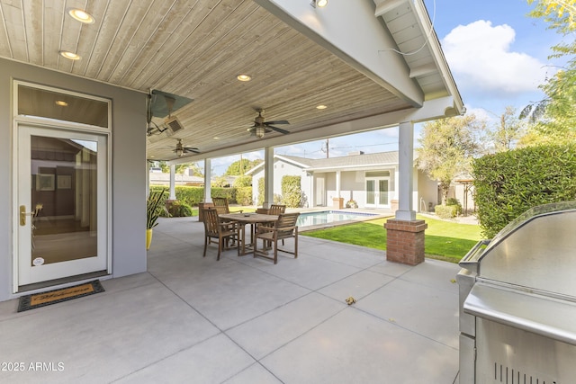 view of patio / terrace featuring ceiling fan and exterior kitchen