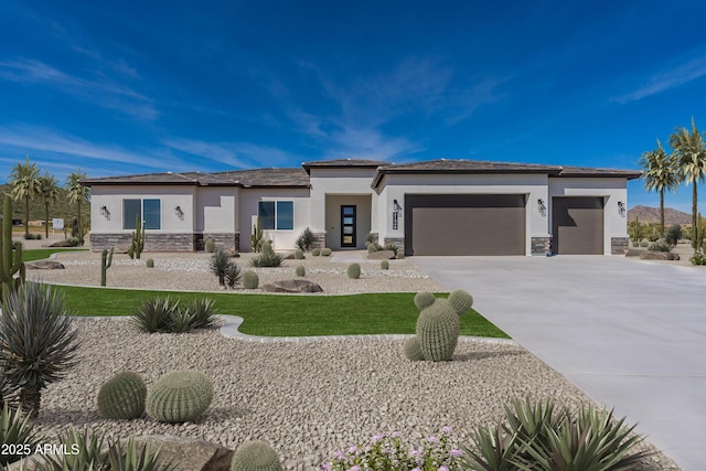 5905 S 182nd Ave, Goodyear, AZ 85338 - prairie-style house with stone siding, stucco siding, a garage, concrete driveway, and a front lawn