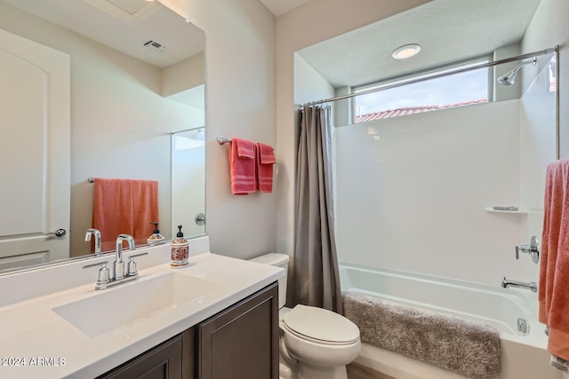 full bathroom featuring shower / bathtub combination with curtain, vanity, and toilet