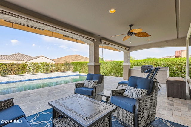 view of patio / terrace featuring a fenced in pool and ceiling fan