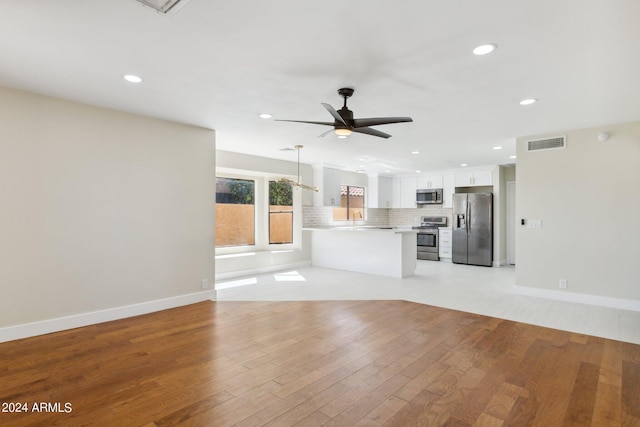unfurnished living room with visible vents, ceiling fan, recessed lighting, and light wood-style floors
