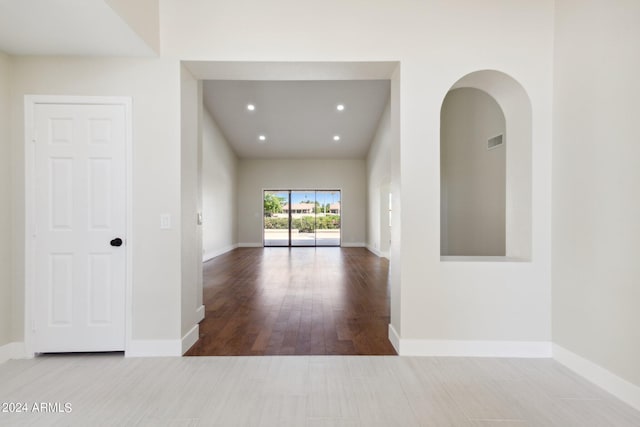 interior space featuring visible vents, baseboards, recessed lighting, and wood finished floors