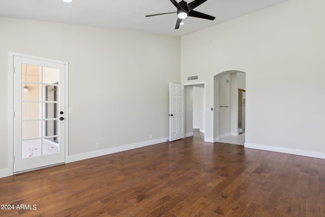 unfurnished room featuring high vaulted ceiling, ceiling fan, and dark wood-type flooring