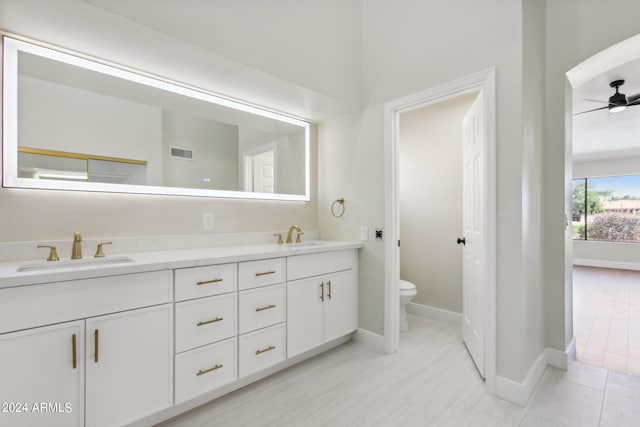 bathroom with ceiling fan, vanity, and toilet