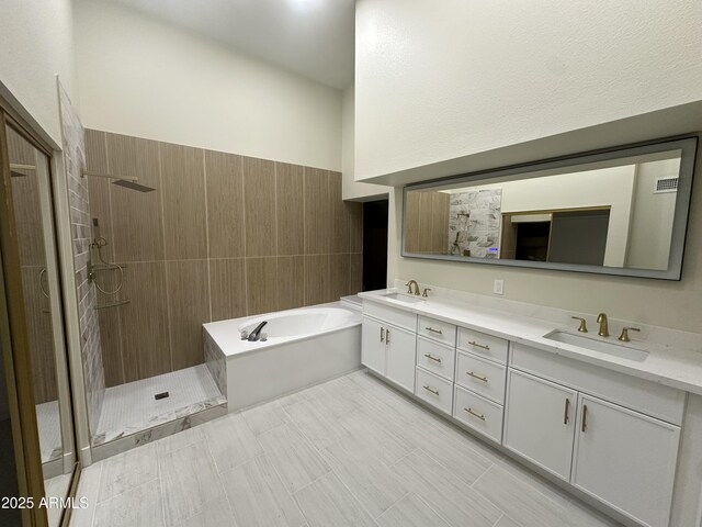 full bath featuring a sink, double vanity, tiled shower, and a garden tub