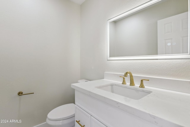 half bathroom with toilet and vanity