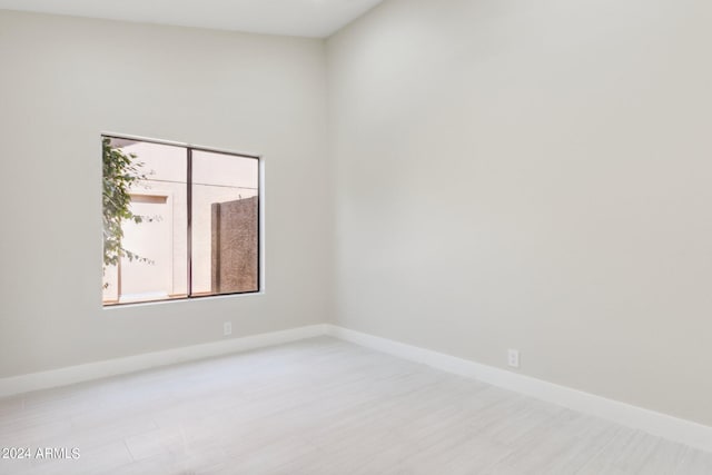 spare room with baseboards